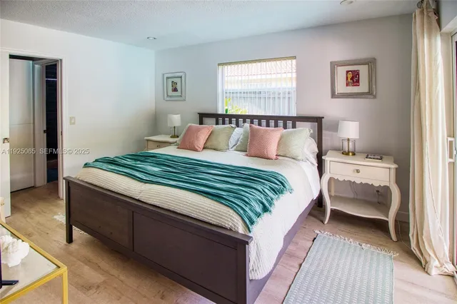 a bedroom with a bed and a night stand