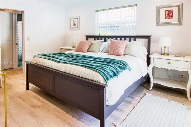 a bedroom with bed and window