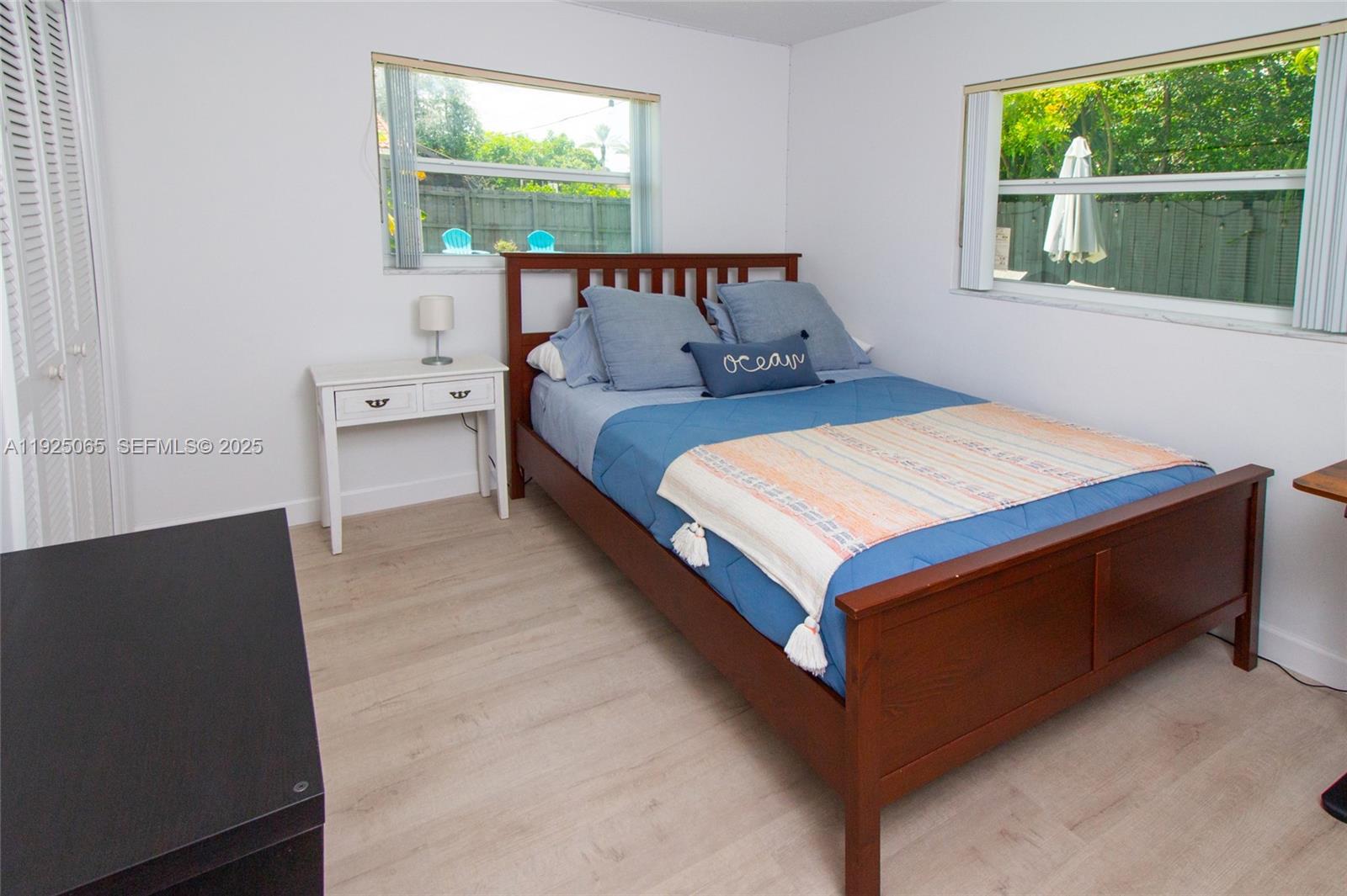 107 Winged Foot Lane Boca Raton, FL 33431 - Photo 33 of 46 a bed sitting in a bedroom next to a window