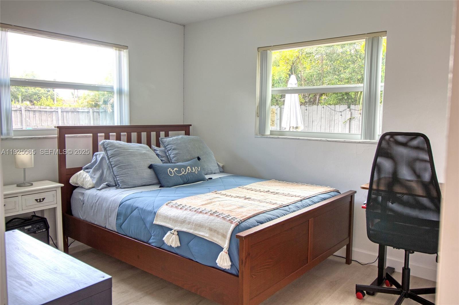 107 Winged Foot Lane Boca Raton, FL 33431 - Photo 35 of 46 a bed sitting in a bedroom next to a window