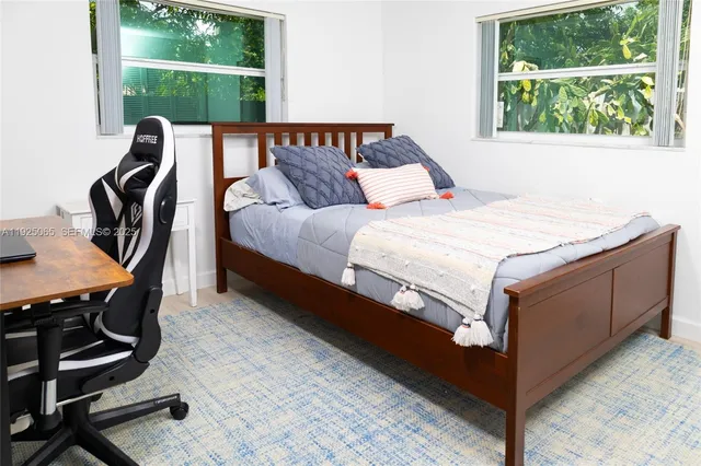 a bed sitting in a room next to a window