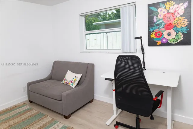 a living room with furniture and a painting on the wall