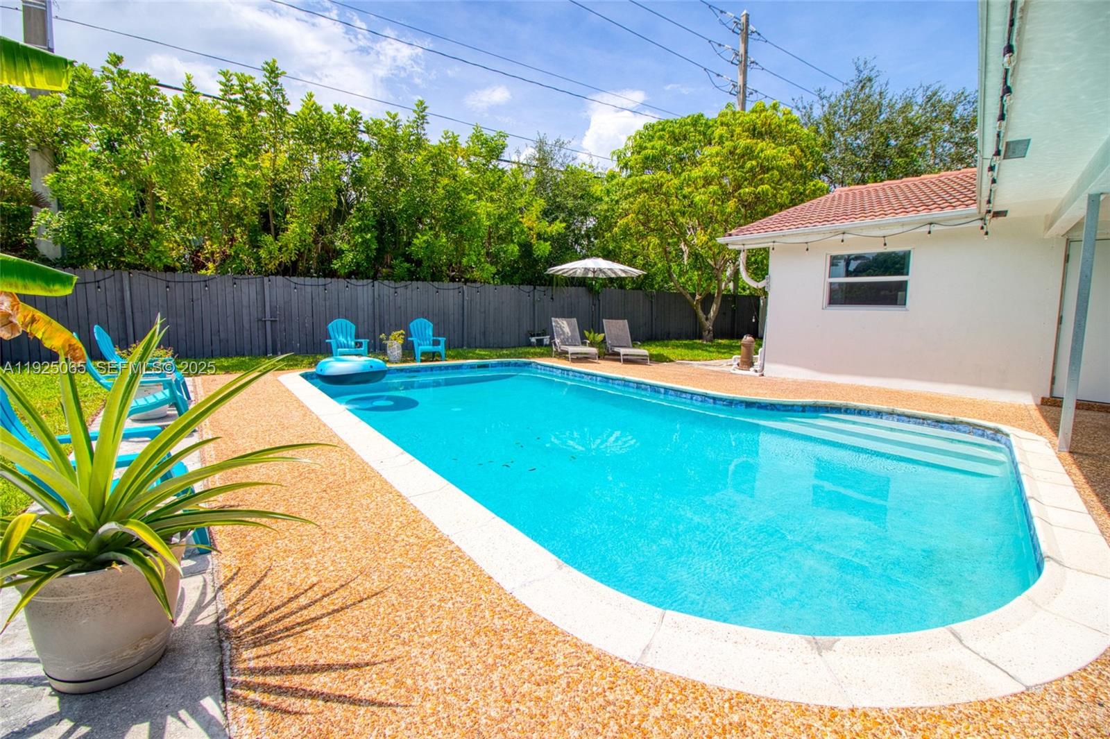 107 Winged Foot Lane Boca Raton, FL 33431 - Photo 41 of 46 a view of a swimming pool with a yard and wooden fence