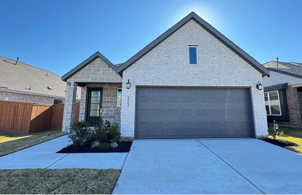 a front view of house with garage and yard