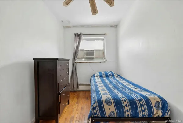 a bedroom with a bed and window
