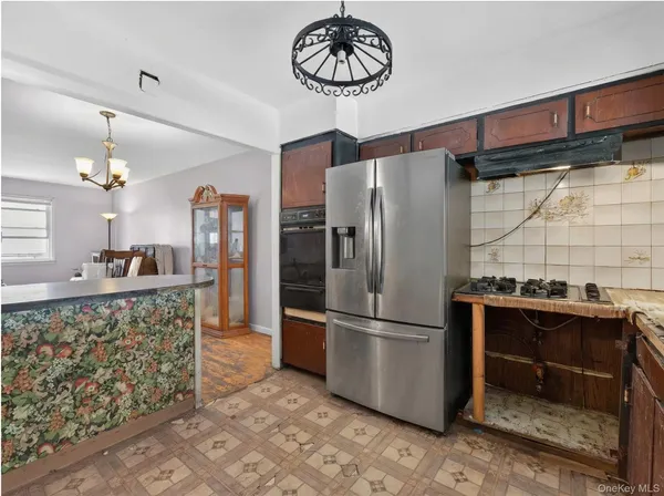 a kitchen with granite countertop a refrigerator and a stove