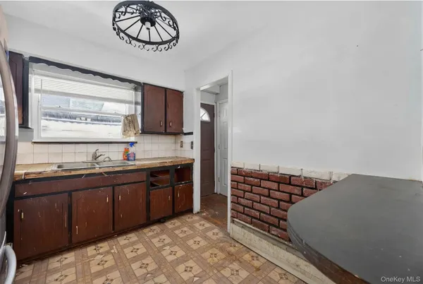 a kitchen with stainless steel appliances a stove a sink and a refrigerator