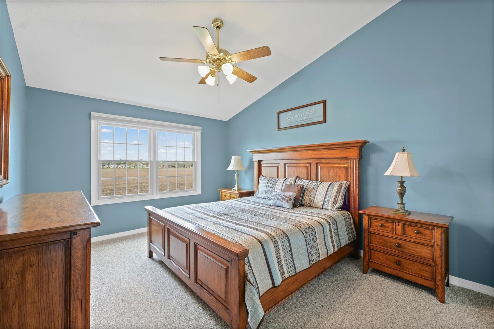 2523 Windward Boulevard, Unit 2523 Champaign, IL 61821 - Photo 13 of 26 a bedroom with a bed a lamp and a chandelier