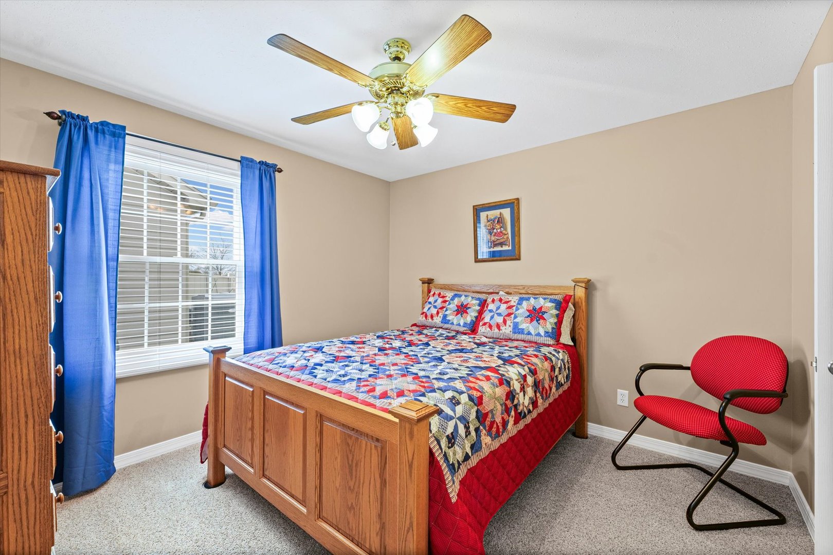 2523 Windward Boulevard, Unit 2523 Champaign, IL 61821 - Photo 18 of 26 a bedroom with a bed and a chandelier