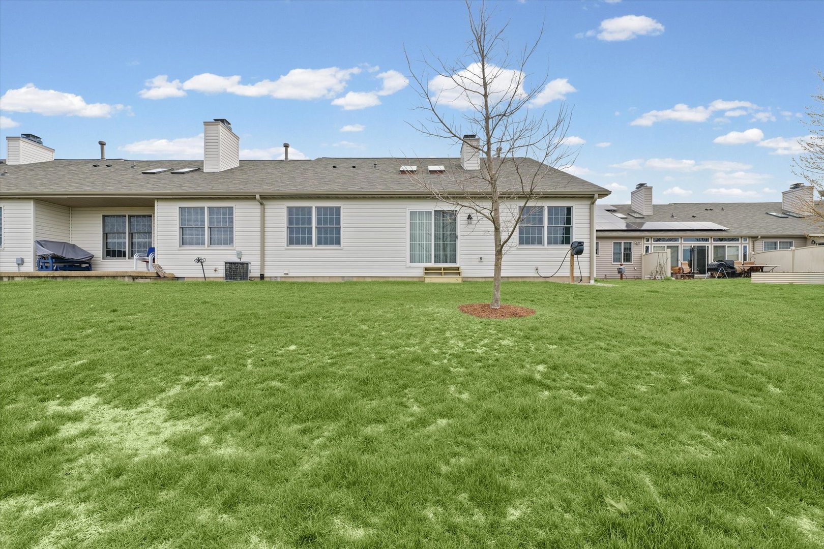 2523 Windward Boulevard, Unit 2523 Champaign, IL 61821 - Photo 25 of 26 a front view of a house with a garden and yard
