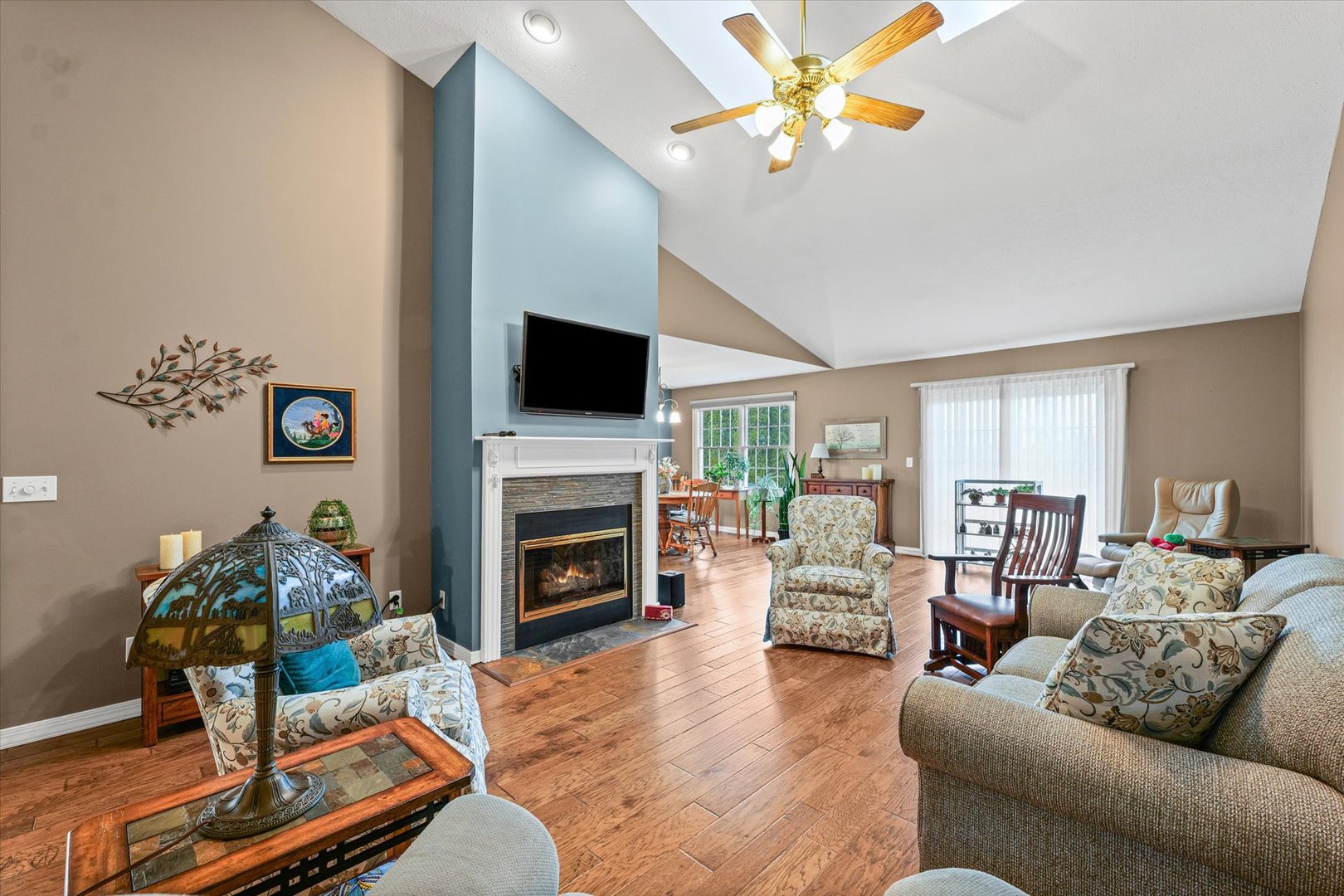 2523 Windward Boulevard, Unit 2523 Champaign, IL 61821 - Photo 4 of 26 a living room with furniture a fireplace and a flat screen tv