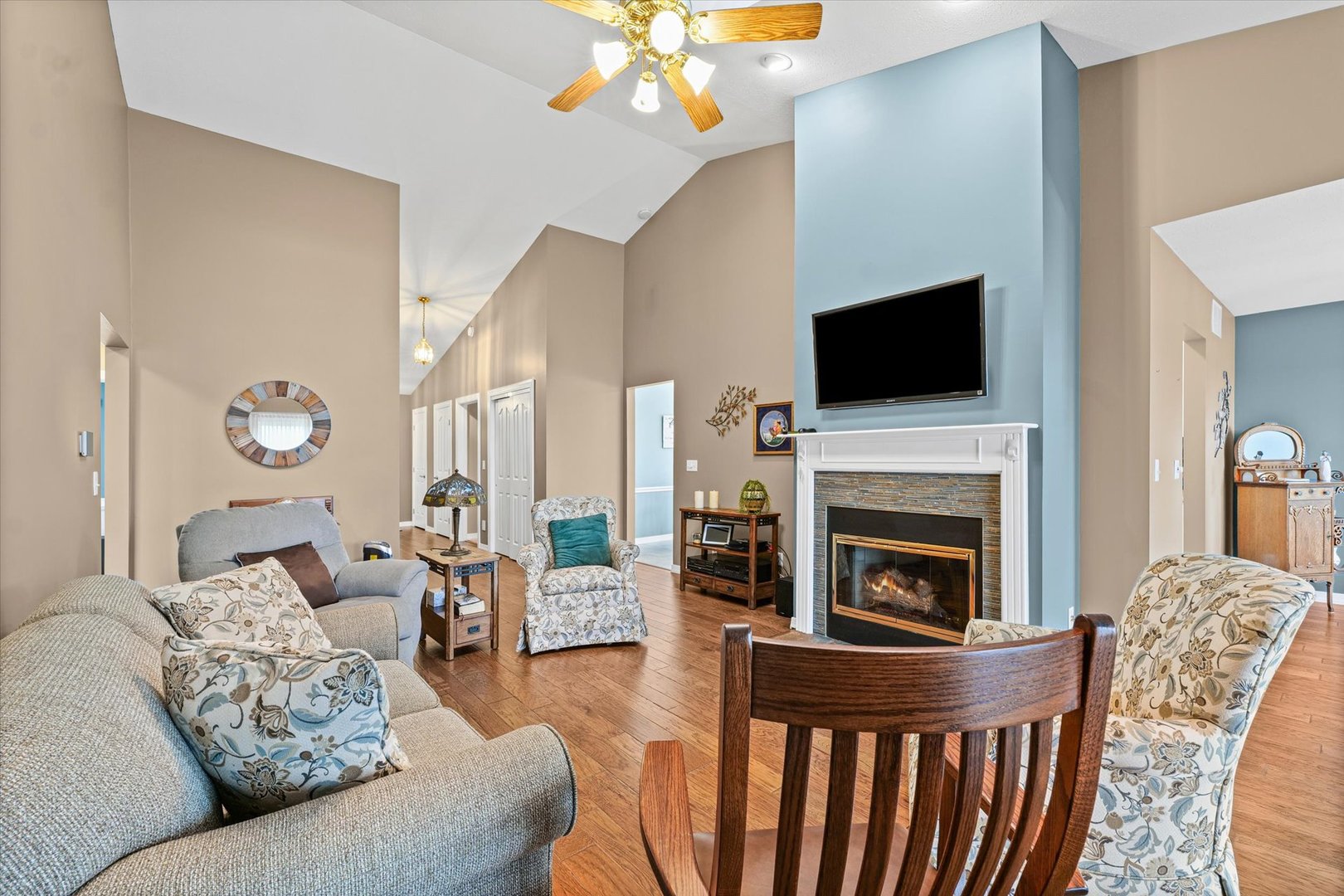 2523 Windward Boulevard, Unit 2523 Champaign, IL 61821 - Photo 5 of 26 a living room with furniture a flat screen tv and a fireplace