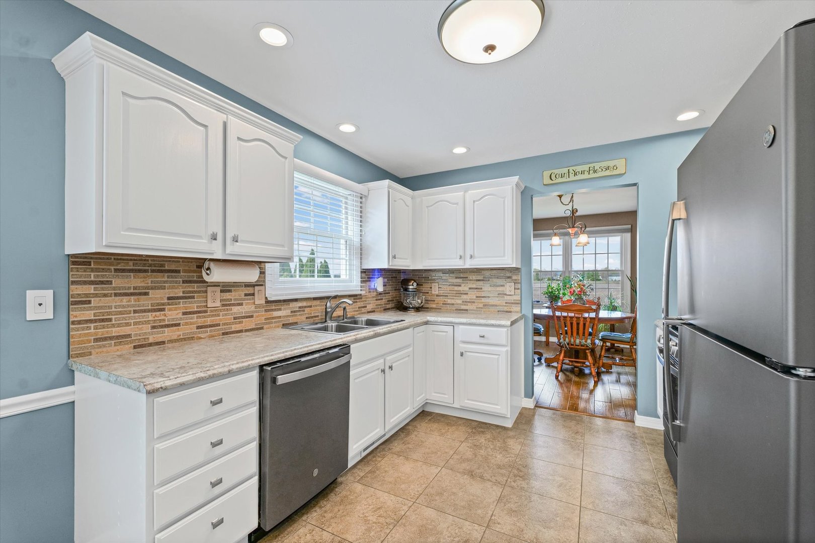 2523 Windward Boulevard, Unit 2523 Champaign, IL 61821 - Photo 9 of 26 a kitchen with granite countertop a sink stove and cabinets