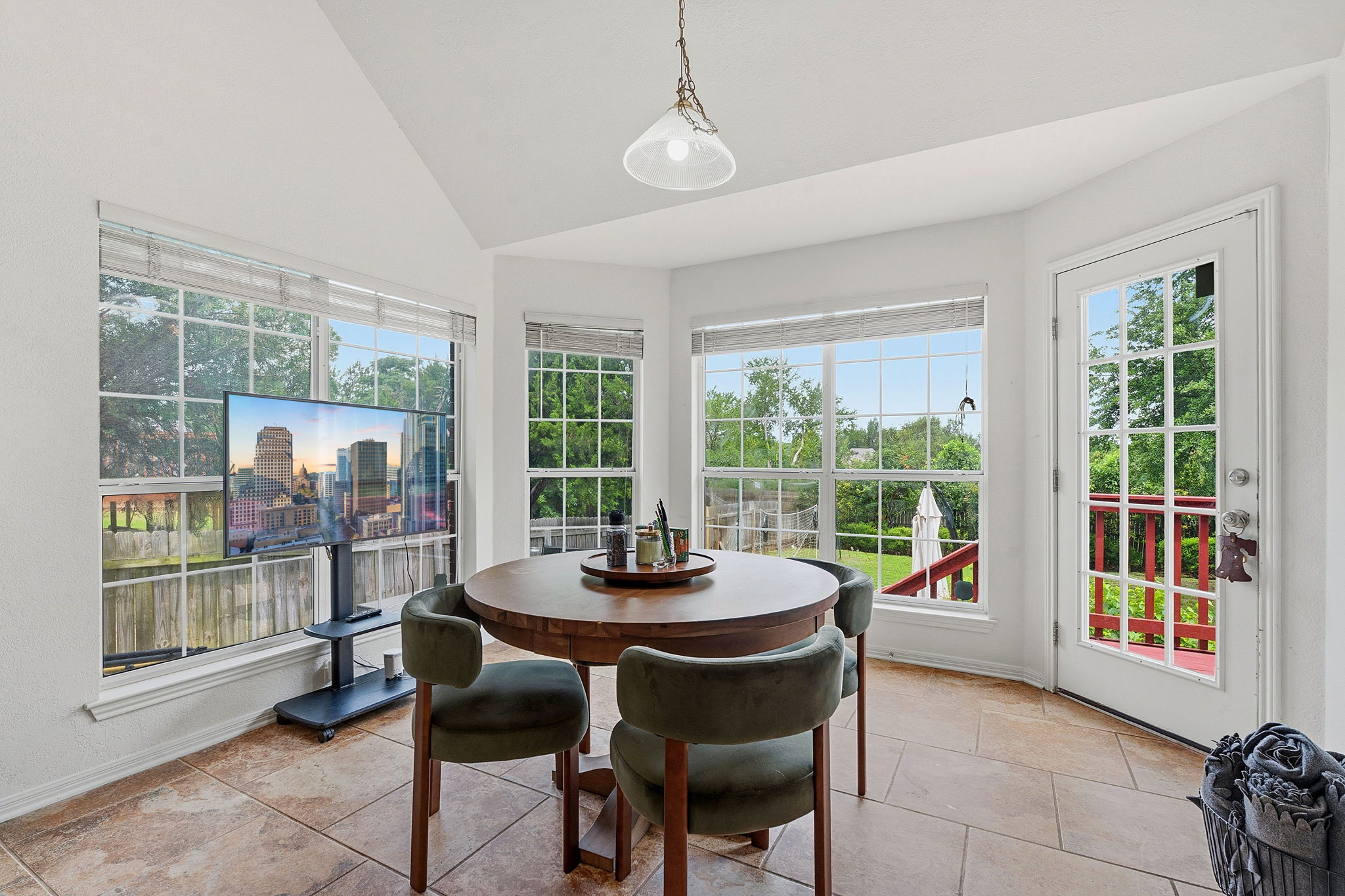 8317 Pommel Drive Austin, TX 78759 - Photo 10 of 26 Natural light floods this dining area, featuring a convenient exterior door leading to outdoor space.