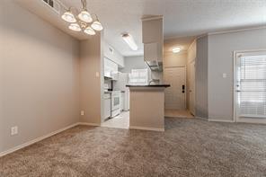 a view of a kitchen with a sink and chandelier