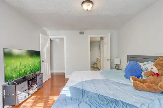 a spacious bedroom with a bed and a garden