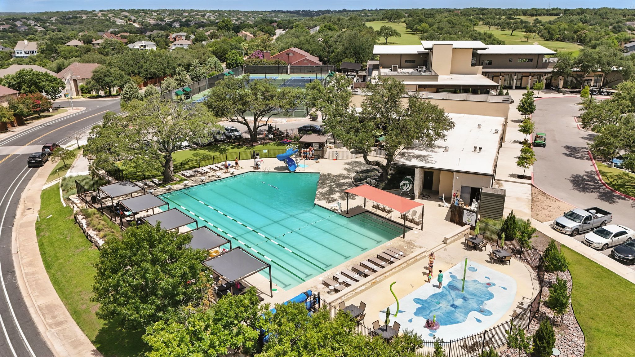 6905 Rudi Cove Austin, TX 78759 - Photo 36 of 37 An aerial perspective reveals a vibrant community pool with adjacent recreational facilities and surrounding homes.
