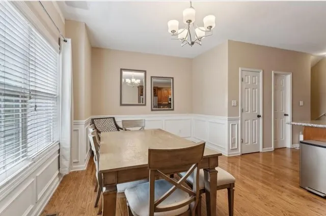 a view of a dining room with furniture wooden floor and chandelier