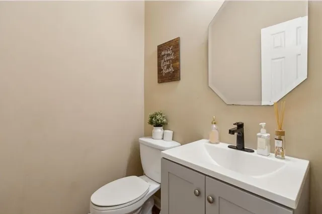 a bathroom with a sink a toilet and mirror