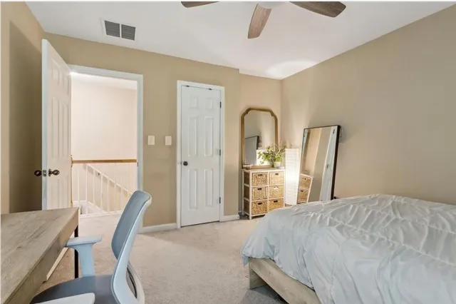 a bedroom with a bed a table and chair