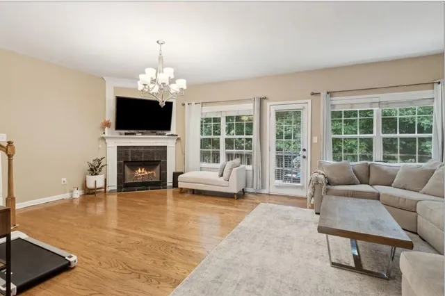 a living room with furniture a fireplace and a flat screen tv