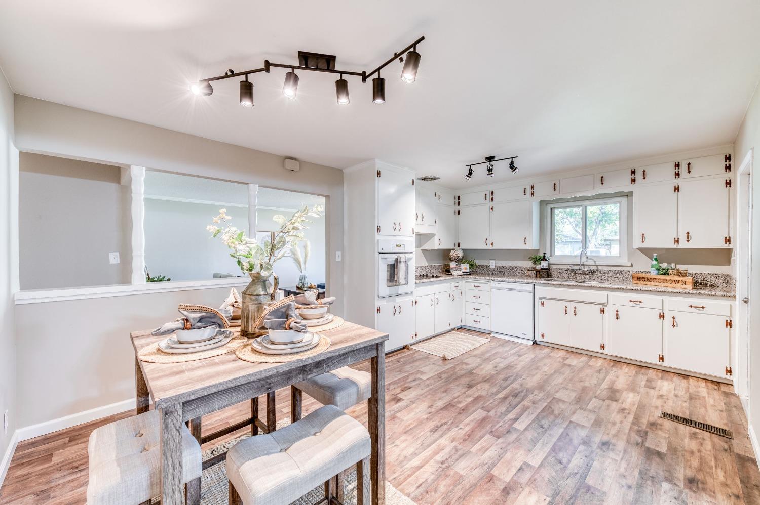 638 West Dennis Drive Clovis, CA 93612 - Photo 13 of 33 a large kitchen with kitchen island a sink table and chairs
