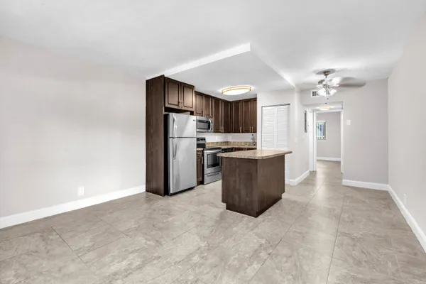 a kitchen with stainless steel appliances a refrigerator and a stove top oven