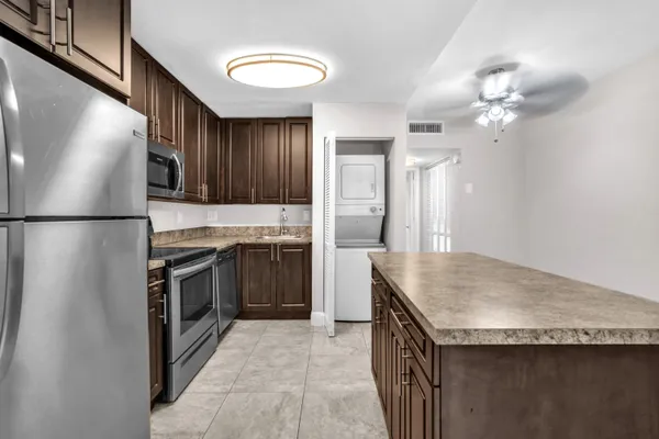 a kitchen with granite countertop a sink and stainless steel appliances