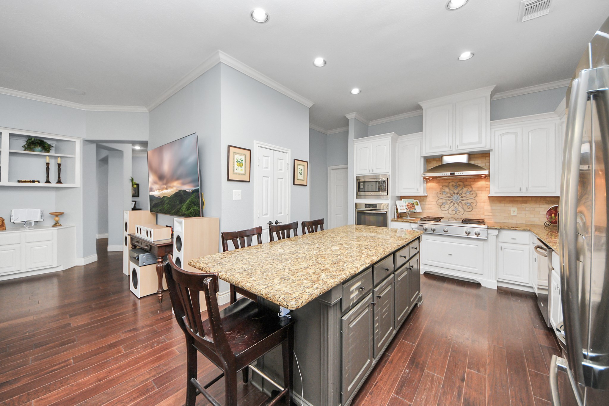 22010 Castlewind Court Katy, TX 77450 - Photo 14 of 41 a kitchen with stainless steel appliances granite countertop a table chairs sink and cabinets