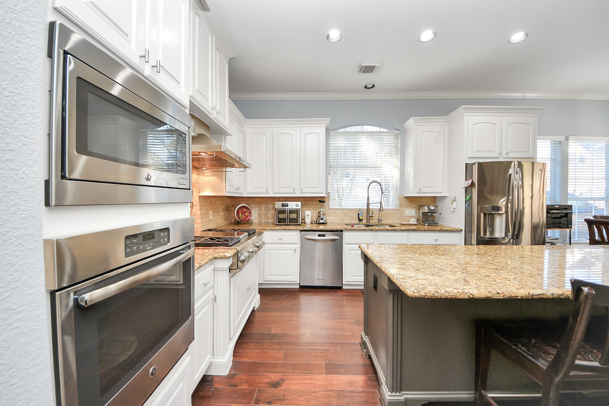 22010 Castlewind Court Katy, TX 77450 - Photo 16 of 41 a kitchen with a refrigerator a sink and a stove