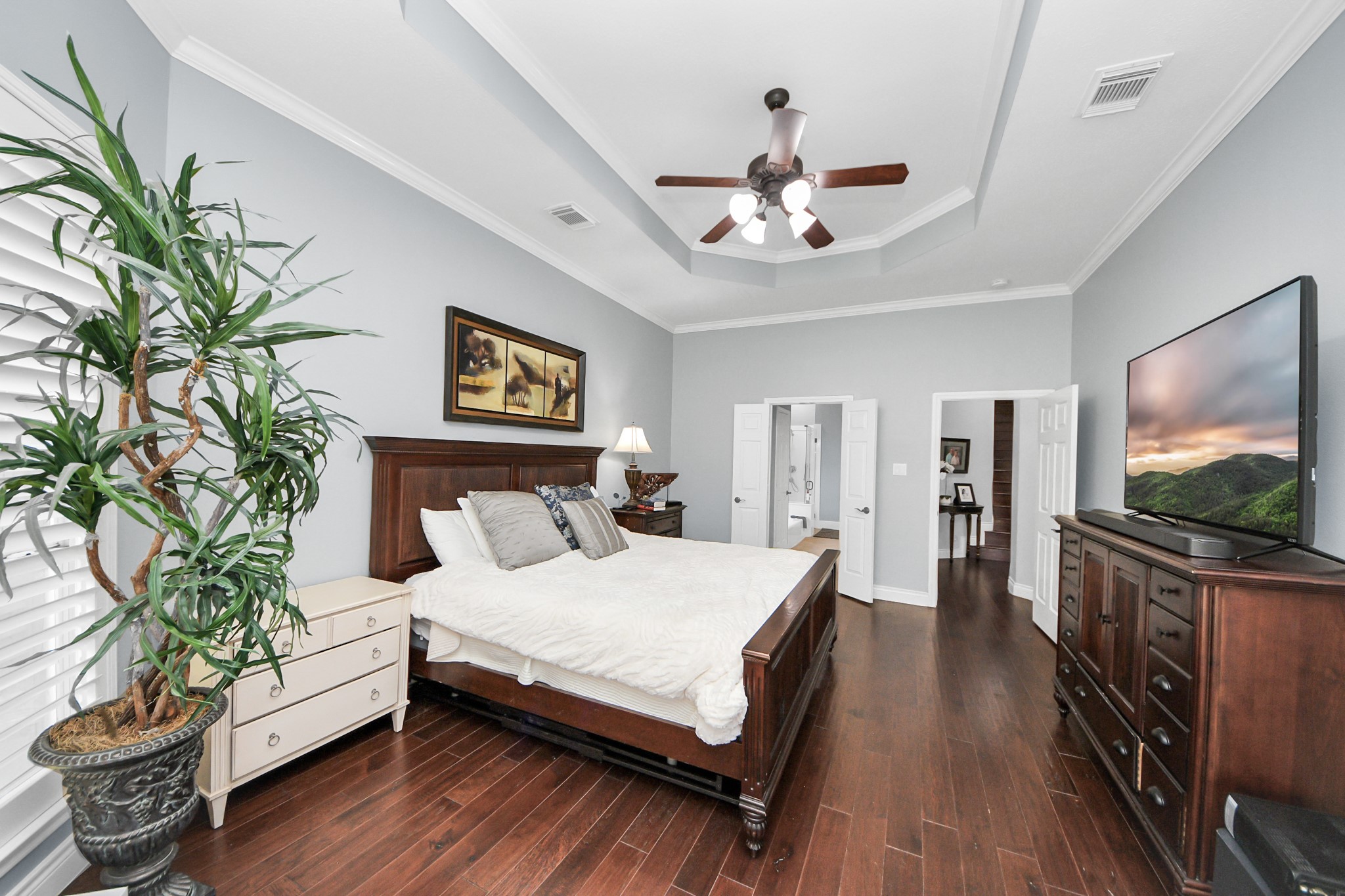 22010 Castlewind Court Katy, TX 77450 - Photo 18 of 41 a bedroom with a large bed and a flat screen tv