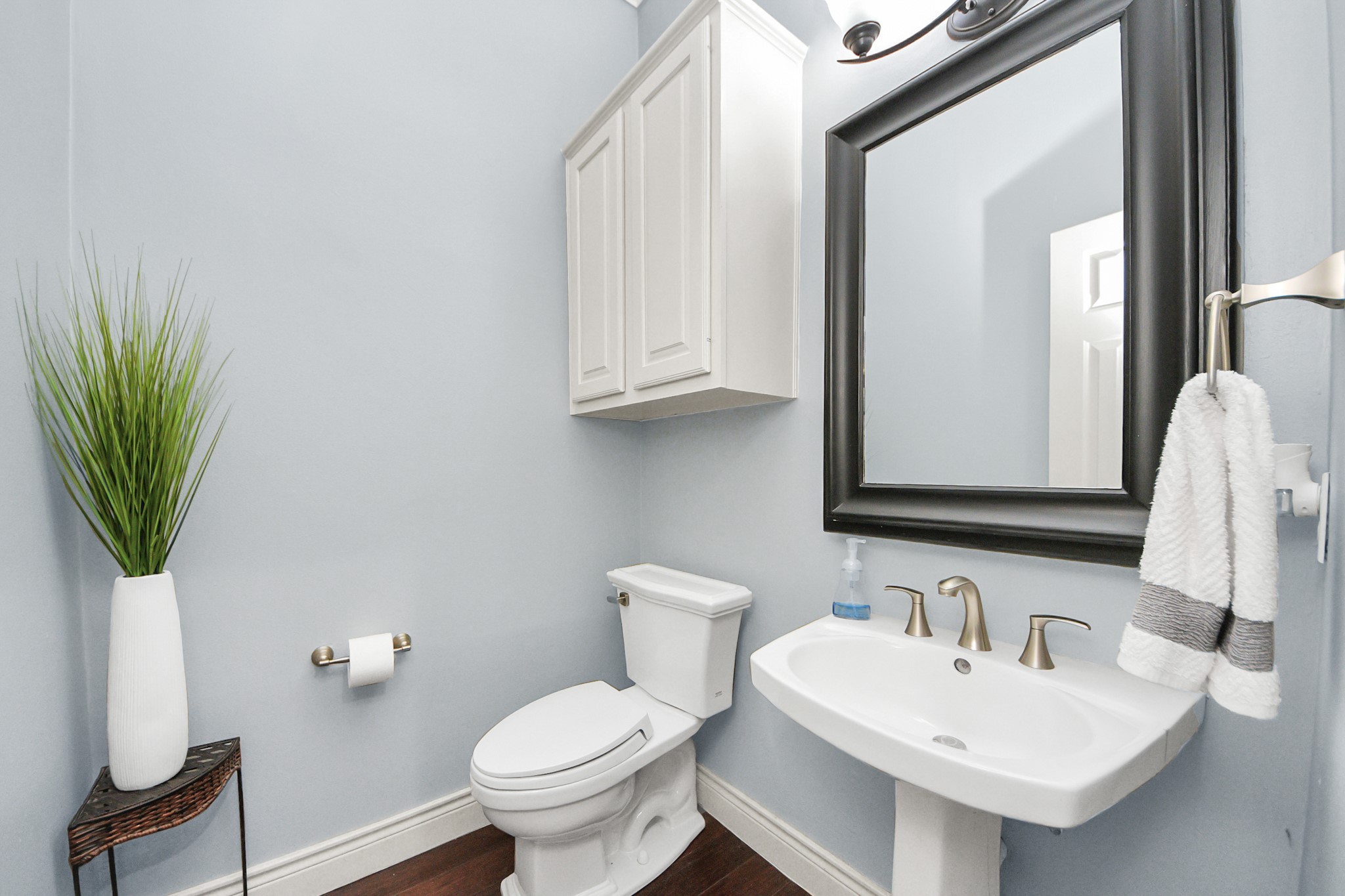 22010 Castlewind Court Katy, TX 77450 - Photo 22 of 41 a bathroom with a sink a toilet and mirror