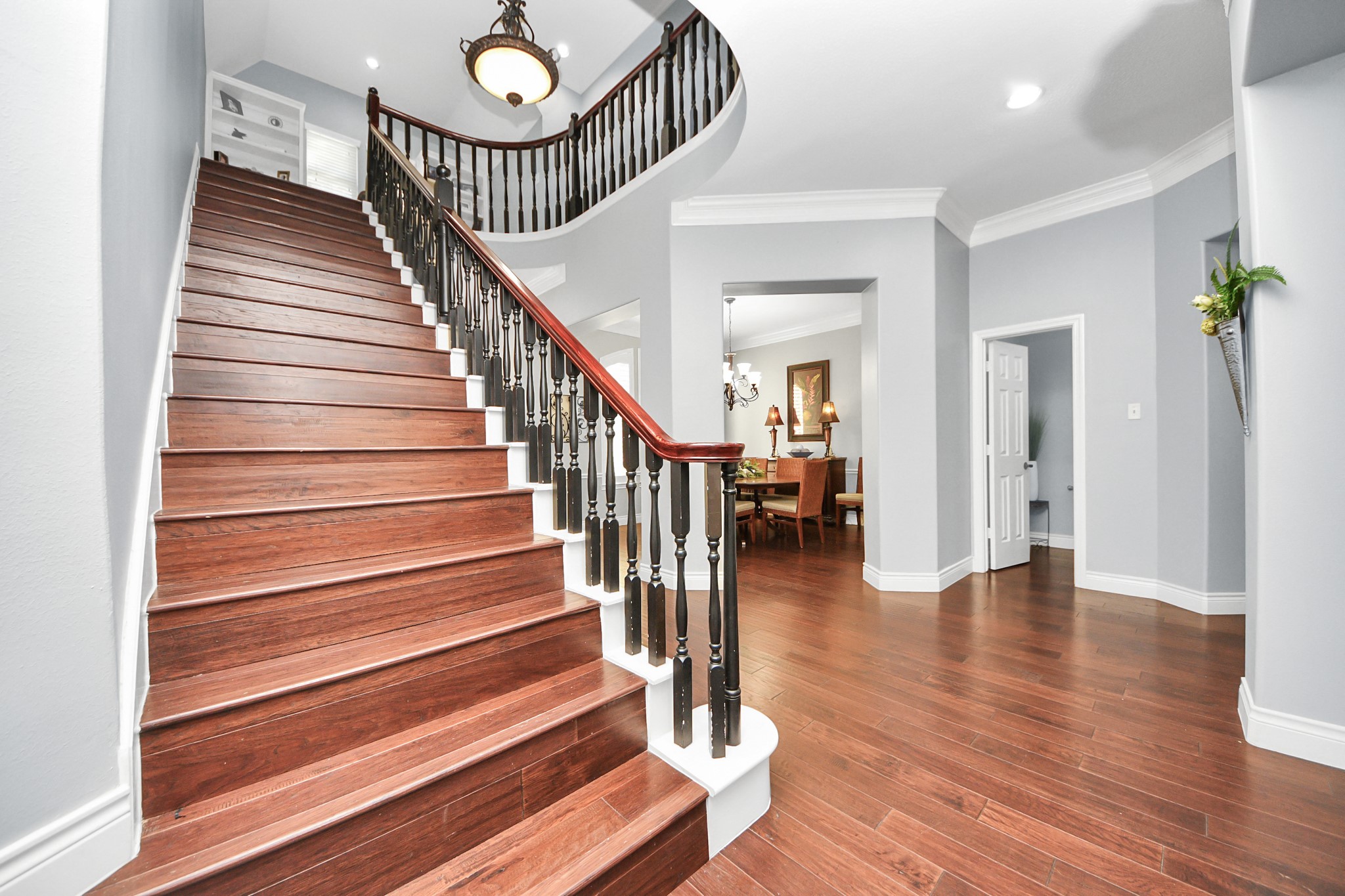 22010 Castlewind Court Katy, TX 77450 - Photo 28 of 41 a view of staircase with wooden floor and a chandelier