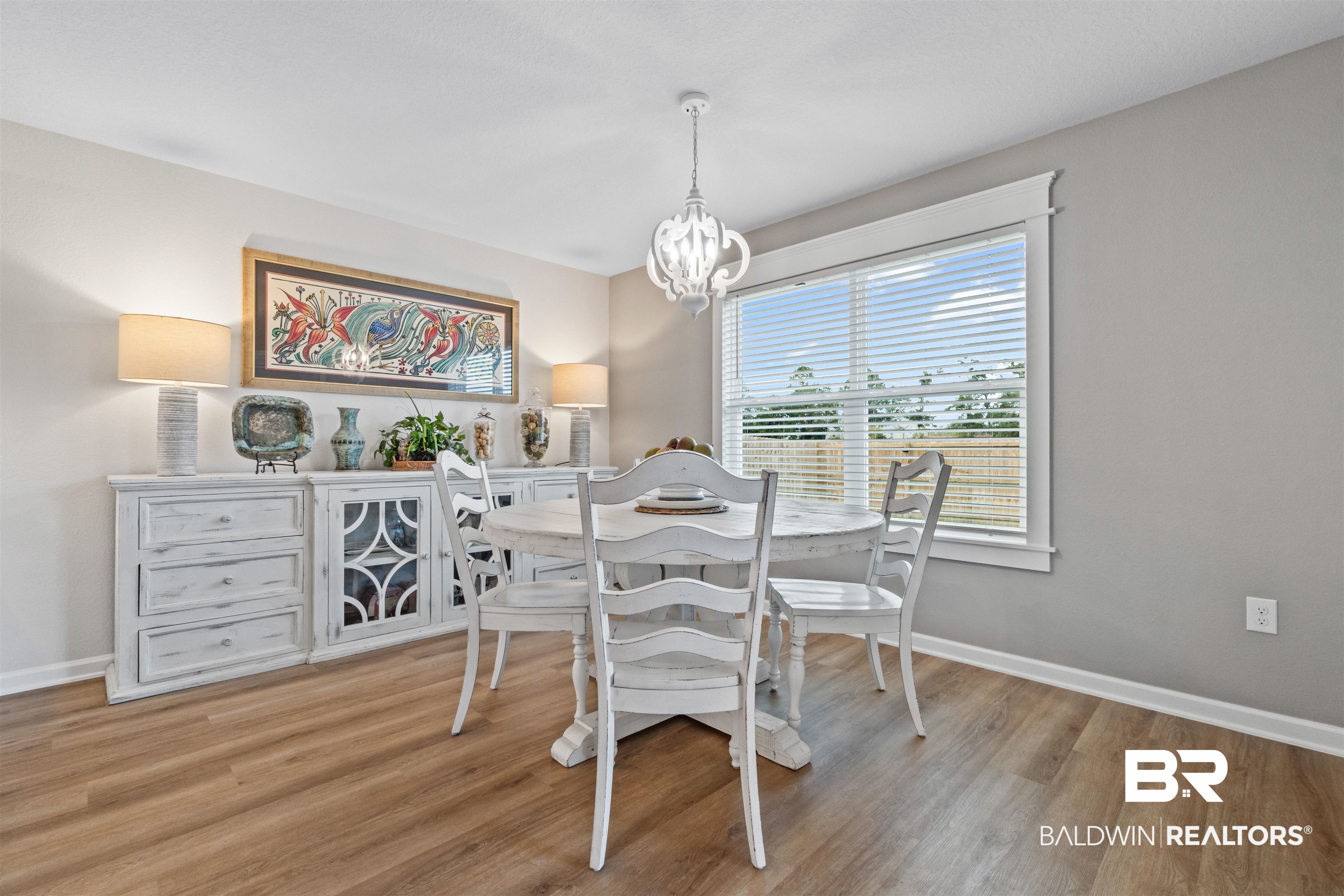 24390 Ringneck Loop Elberta, AL 36530 - Photo 13 of 39 Dining room featuring light wood-type flooring and a chandelier