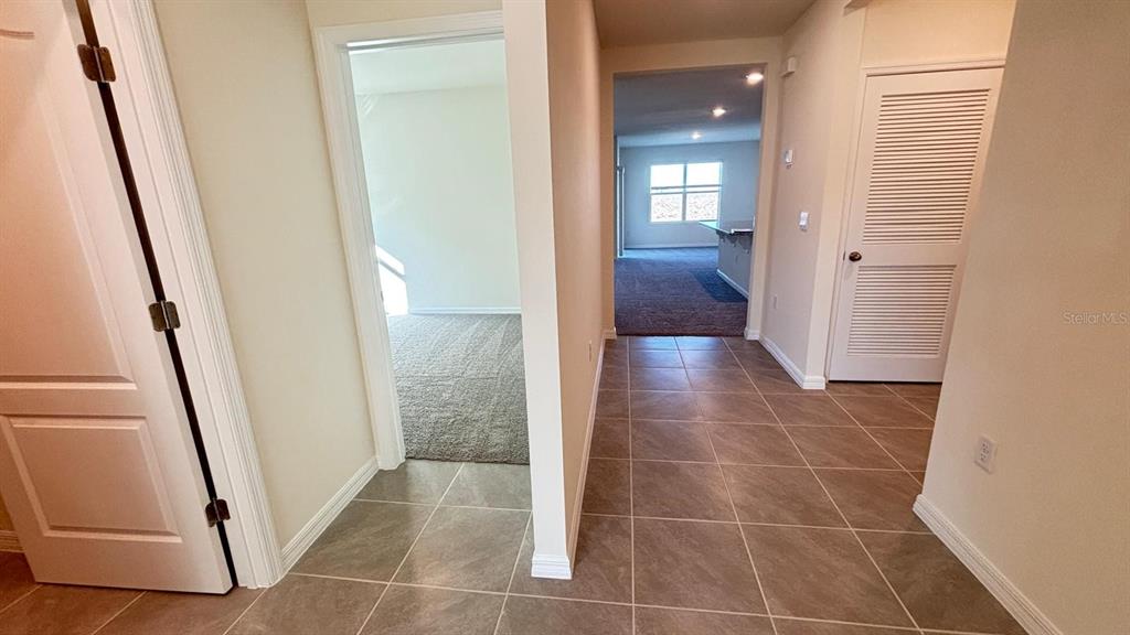 914 Princess Sabal Point Haines City, FL 33844 - Photo 30 of 39 a view of a hallway with wooden floor and staircase