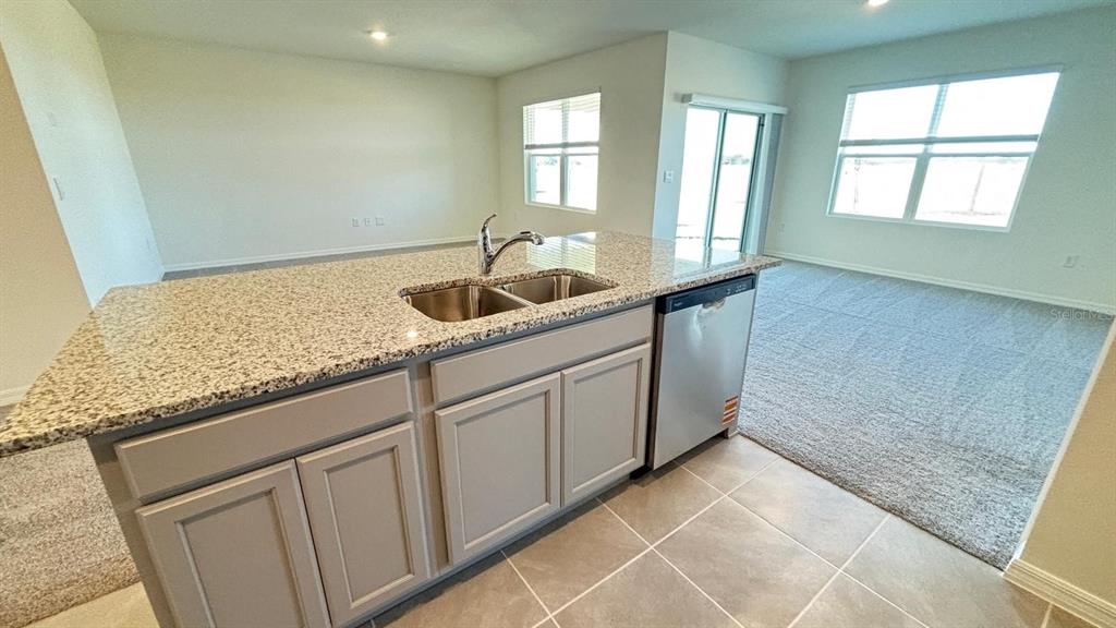 914 Princess Sabal Point Haines City, FL 33844 - Photo 10 of 39 a kitchen with granite countertop white cabinets and window