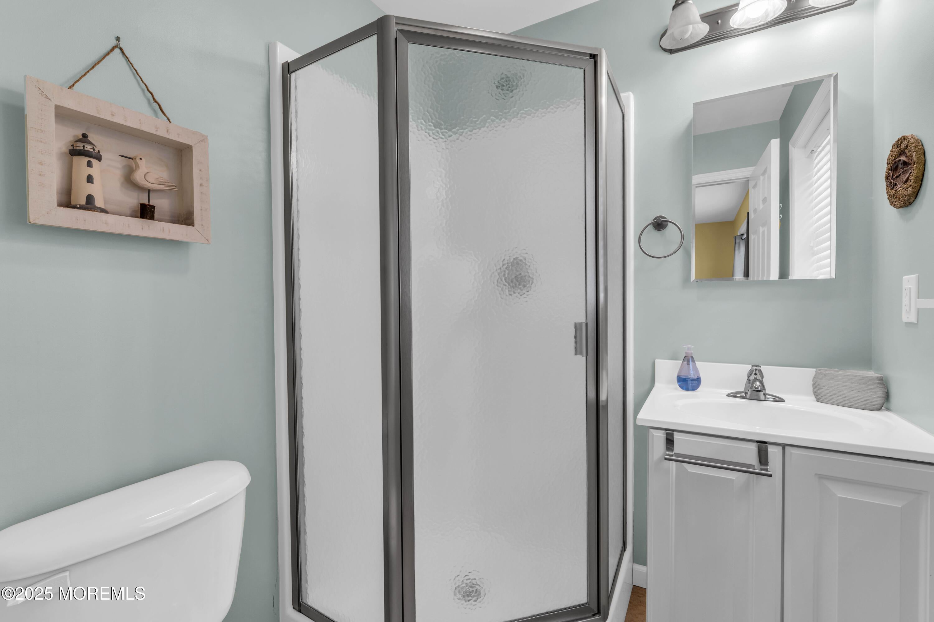 111 7th Avenue Seaside Park, NJ 08752 - Photo 20 of 46 a bathroom with a toilet sink vanity and mirror