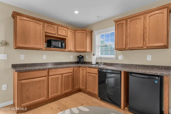 a living room with furniture and kitchen view