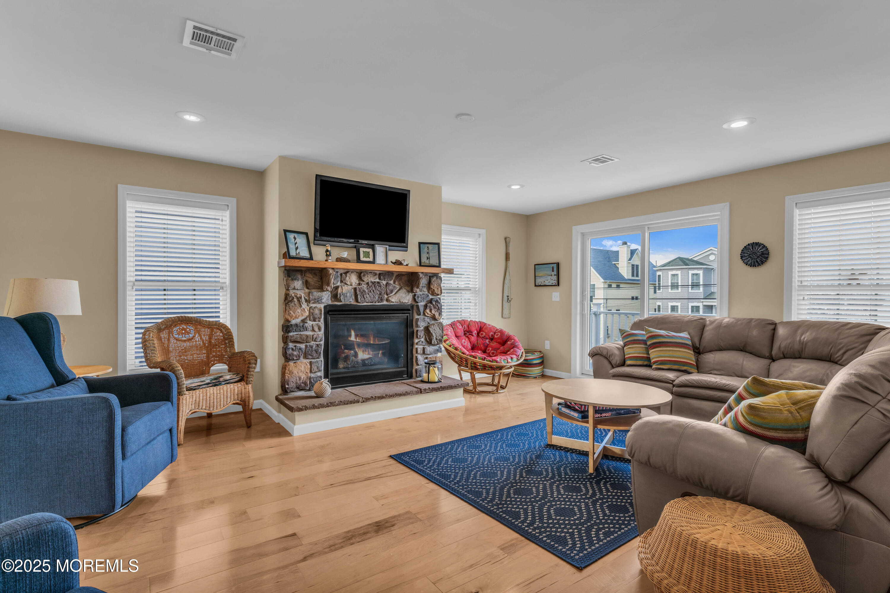 111 7th Avenue Seaside Park, NJ 08752 - Photo 26 of 46 a living room with furniture a flat screen tv and a fireplace