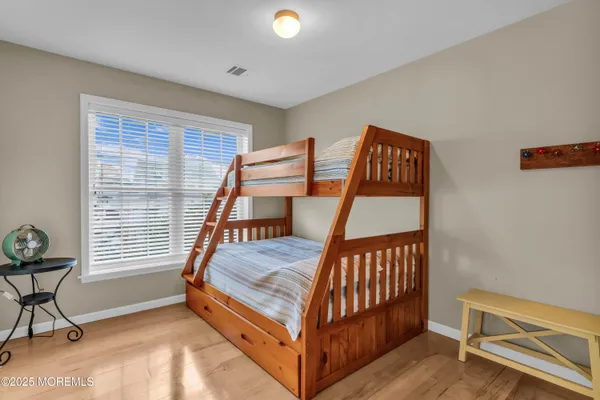 a bedroom with a bed a table and chair