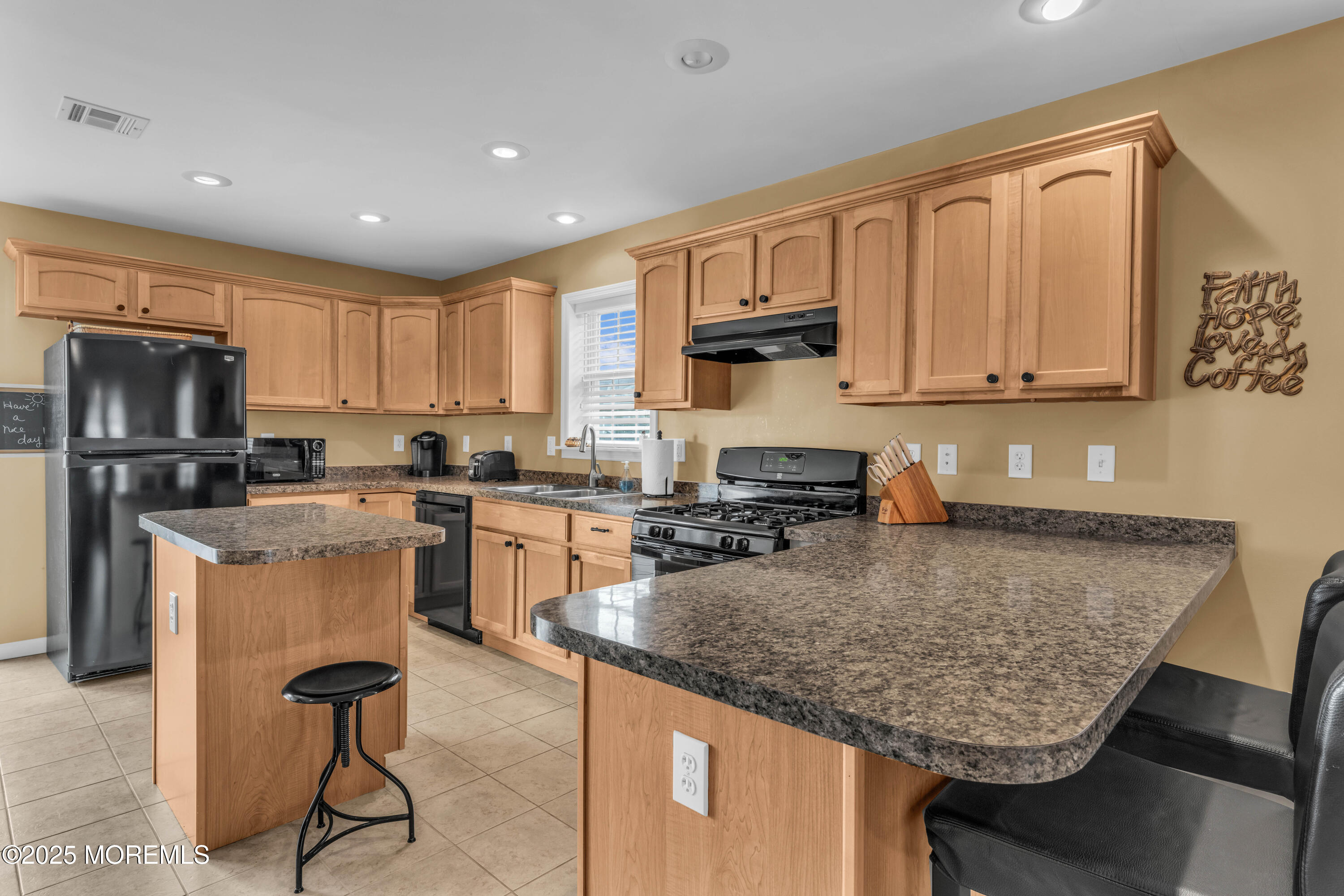 111 7th Avenue Seaside Park, NJ 08752 - Photo 37 of 46 a kitchen with kitchen island granite countertop wooden cabinets a sink dishwasher a stove and a refrigerator with wooden floor