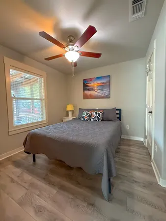 a bedroom with a bed and a window