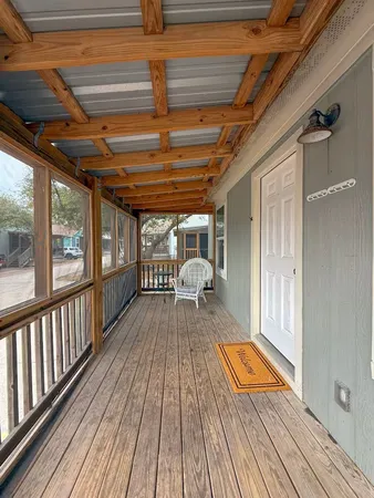a view of a balcony with wooden floor