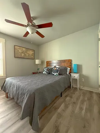 a bedroom with a large bed and a chandelier