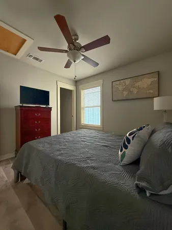 a bedroom with a bed and window