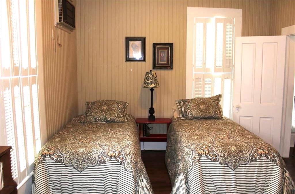 801 North Lane Street Comanche, TX 76442 - Photo 12 of 19 a bedroom with a bed and wooden floor