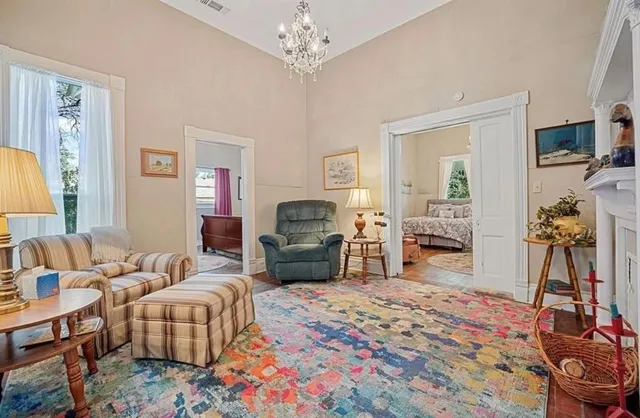 a bedroom with furniture and a flat screen tv