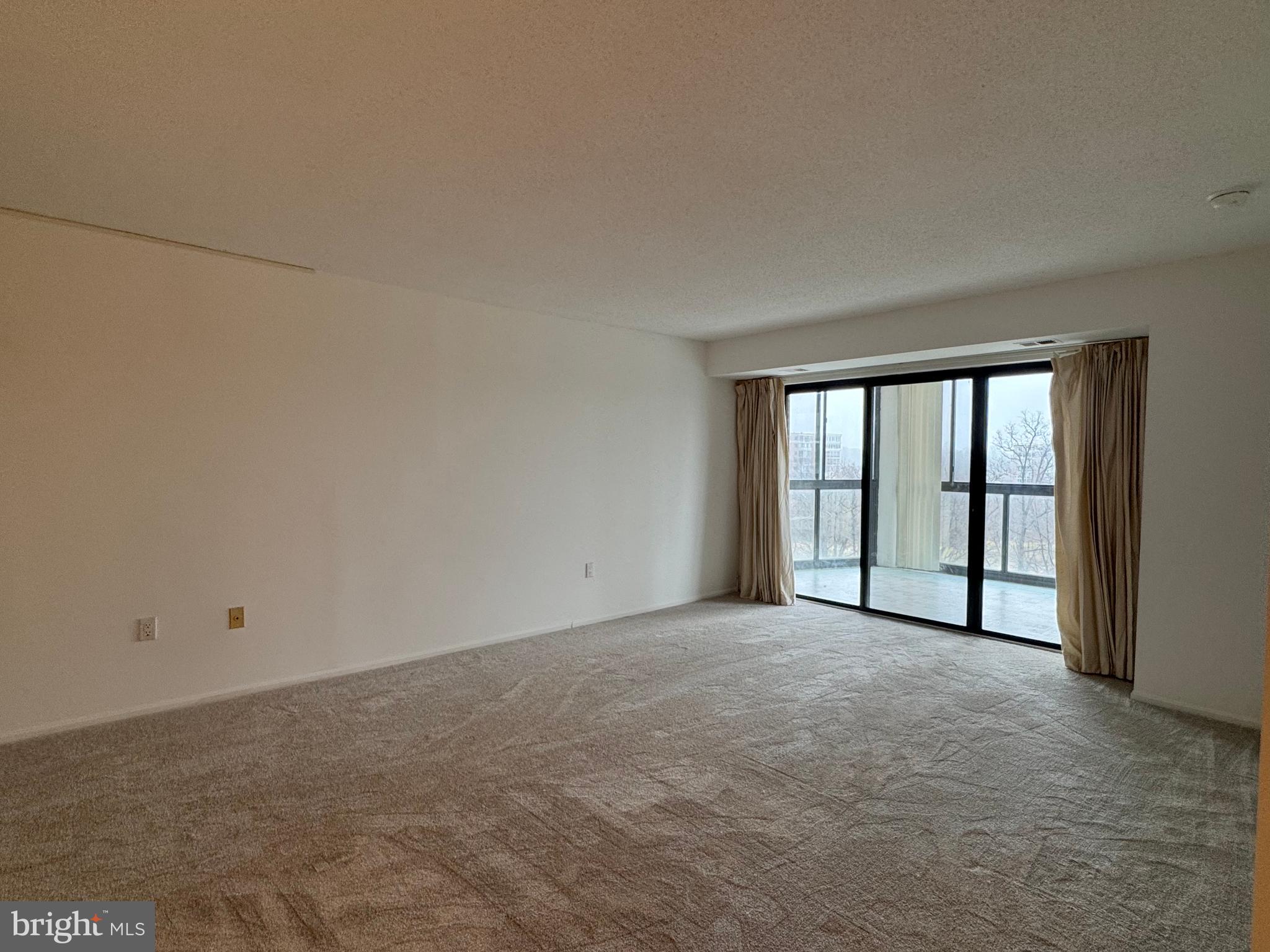 15115 Interlachen Drive, Unit 3815 Silver Spring, MD 20906 - Photo 3 of 22 a view of an empty room with a window