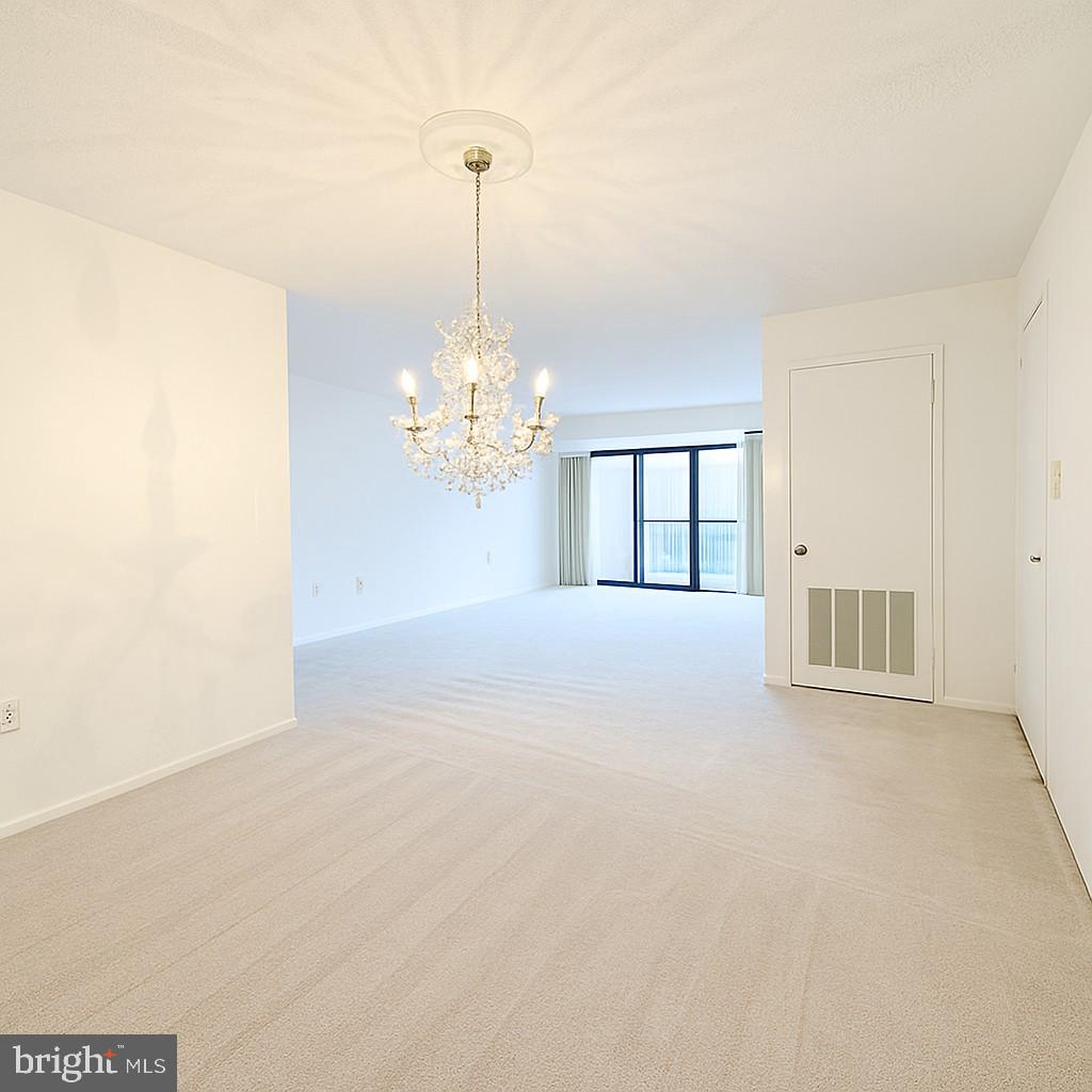 15115 Interlachen Drive, Unit 3815 Silver Spring, MD 20906 - Photo 22 of 22 a view of an empty room with a chandelier