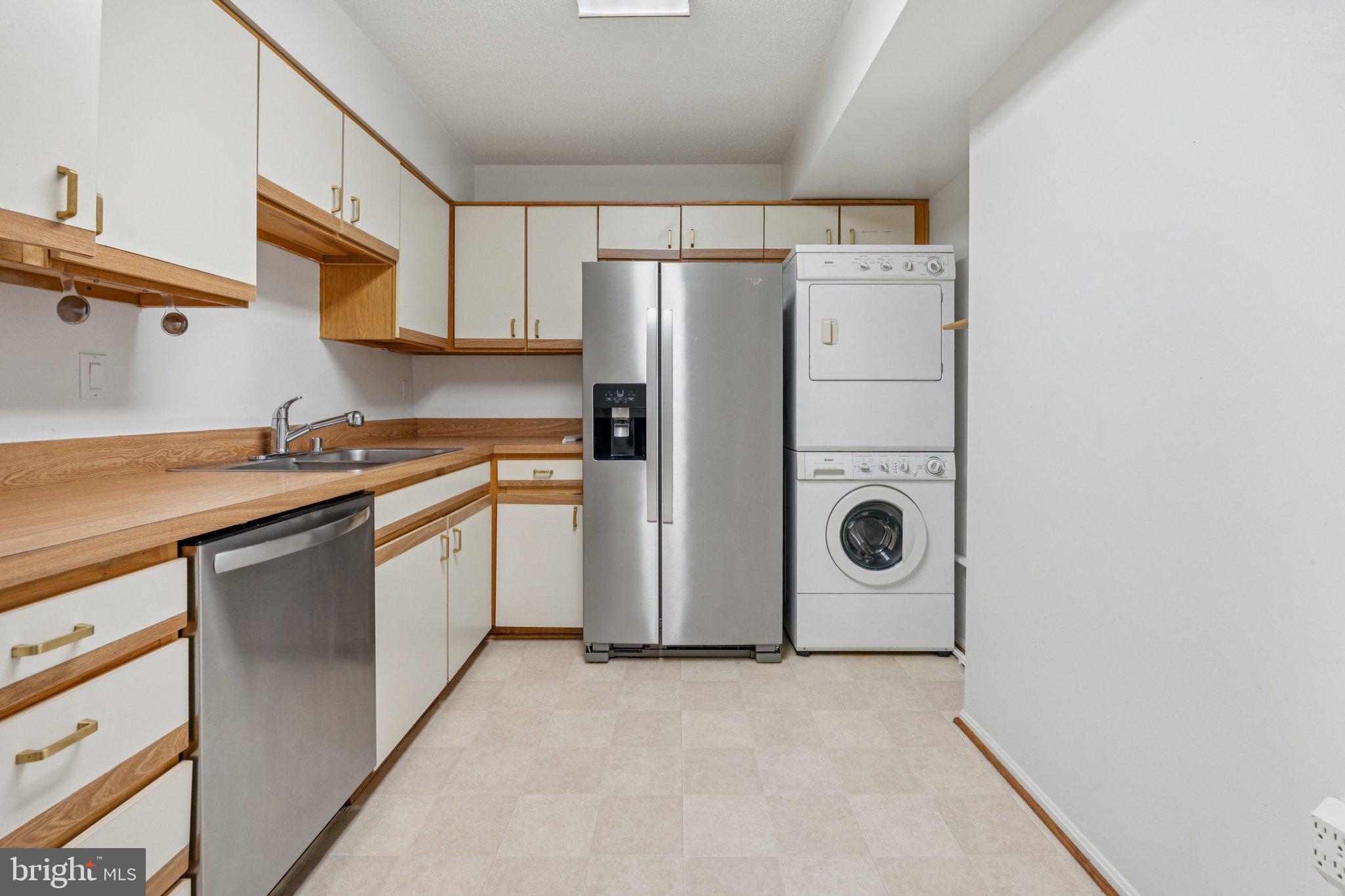 15115 Interlachen Drive, Unit 3815 Silver Spring, MD 20906 - Photo 9 of 22 a kitchen with a refrigerator sink stove and cabinets